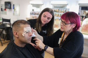 Makeup application during professional training session.